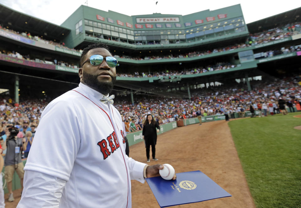 Retired Boston Red Sox player David Ortiz looks at the large television screen Friday, June 23, 2017, at Fenway Park in Boston as the team retired his jersey No. 34 worn when he led the franchise to three World Series titles. It is the 11th number retired by the Red Sox. (AP Photo/Elise Amendola)