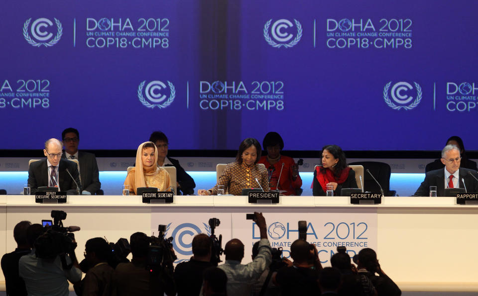 Organizers are seen on stage at the opening ceremony of the 18th United Nations climate change conference in Doha, Qatar, Monday, Nov. 26, 2012. U.N. talks on a new climate pact resumed Monday in oil and gas-rich Qatar, where negotiators from nearly 200 countries will discuss fighting global warming and helping poor nations adapt to it. The two-decade-old talks have not fulfilled their main purpose: reducing the greenhouse gas emissions that scientists say are warming the planet. (AP Photo/Osama Faisal)