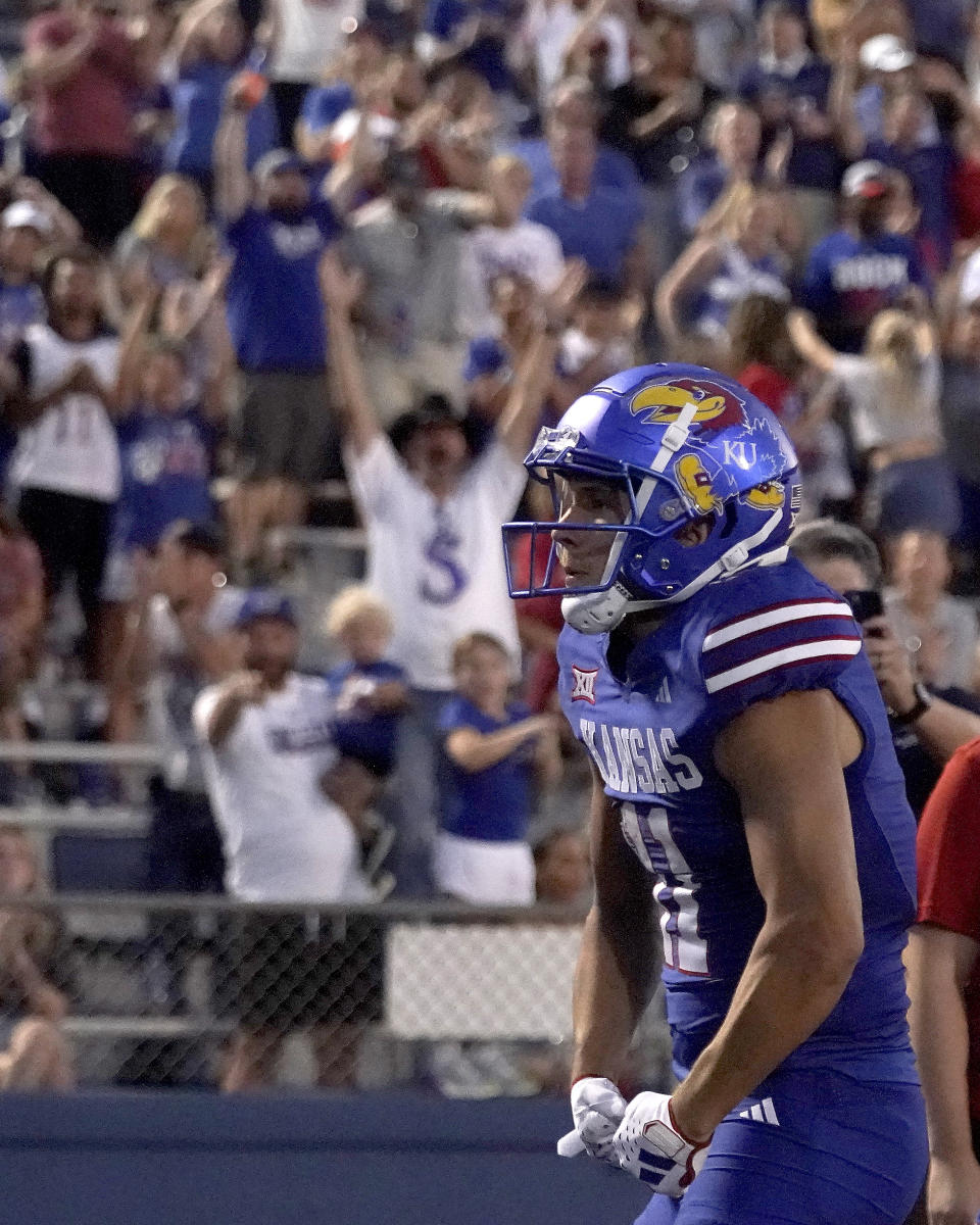 Kansas wide receiver Luke Grimm (11) celebrates after scoring a touchdown during the first half of an NCAA college football game against Missouri State Friday, Sept. 1, 2023, in Lawrence, Kan. (AP Photo/Charlie Riedel)