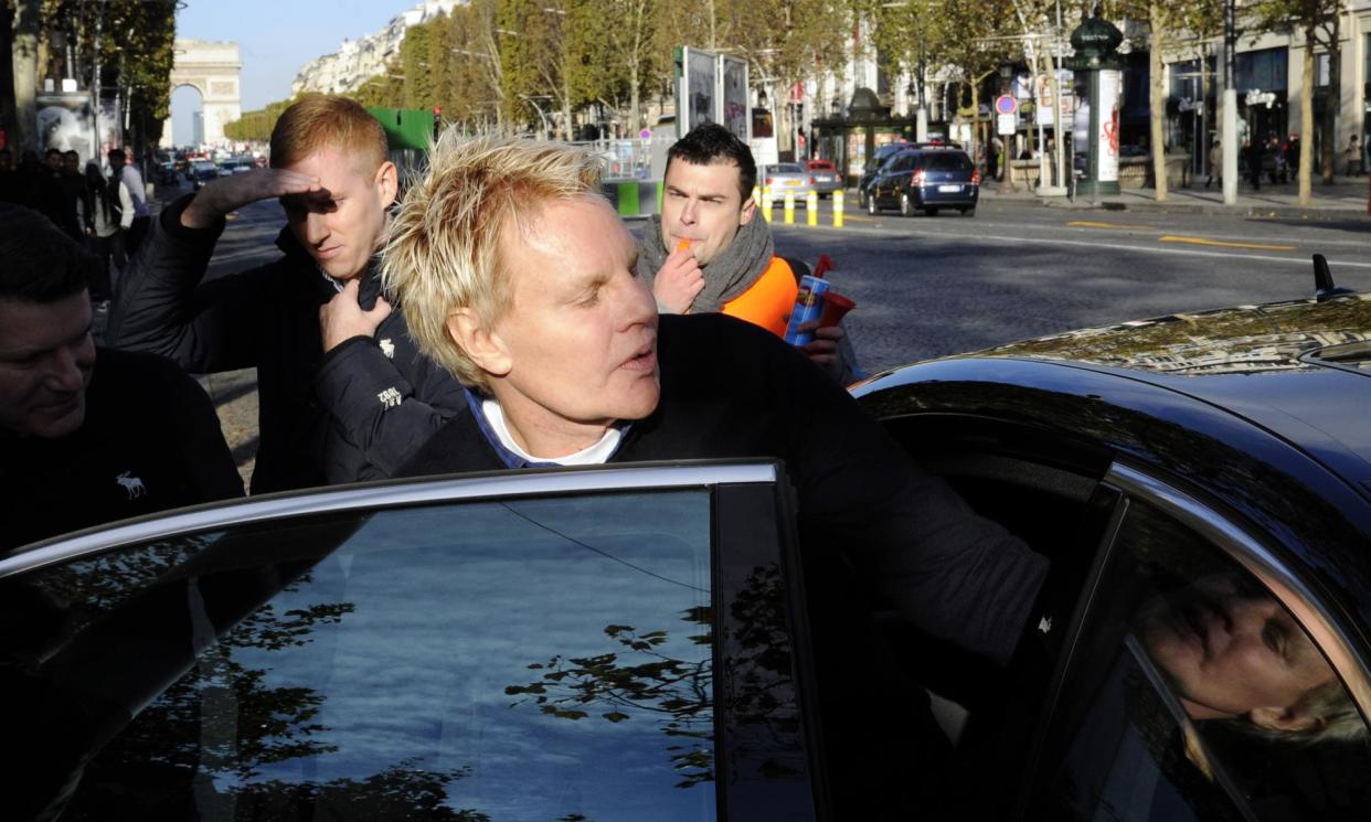 <span>Mike Jeffries, ex-CEO of fashion chain Abercrombie & Fitch, leaving the store on the Champs-Élysées in Paris in 2012.</span><span>Photograph: Bertrand Guay/AFP/Getty Images</span>