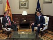 Spain's acting Prime Minister Mariano Rajoy (L) and Socialists (PSOE) leader Pedro Sanchez sit at the start of their meeting at Parliament in Madrid, Spain, February 12, 2016. REUTERS/Sergio Perez