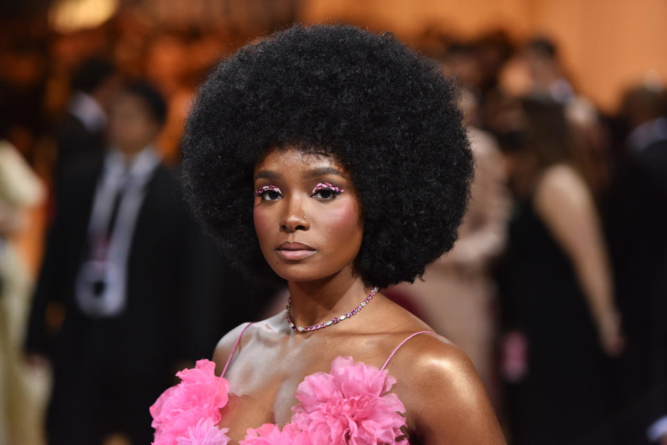 Kiki rocking an afro and a flora dress at an event