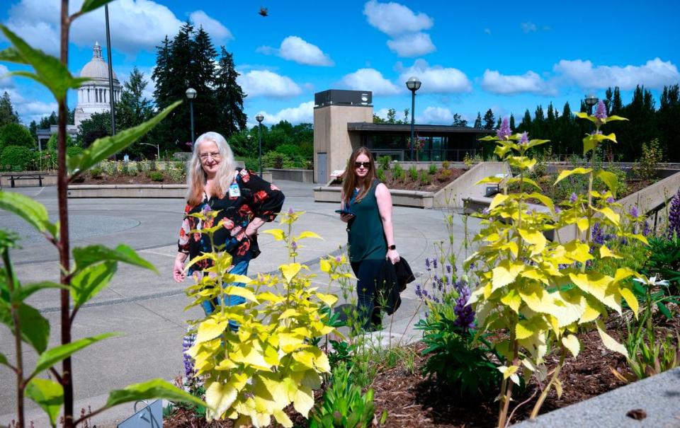 State workers Patty Boyer (left) of Lacey and Rachel Robbie of Olympia visit the Capitol Campus Pollinator Garden on the East Capitol Campus in Olympia, Washington on Thursday, June 30, 2022. Boyer said she researches and plants butterfly- and bee-friendly flowers in her home garden.