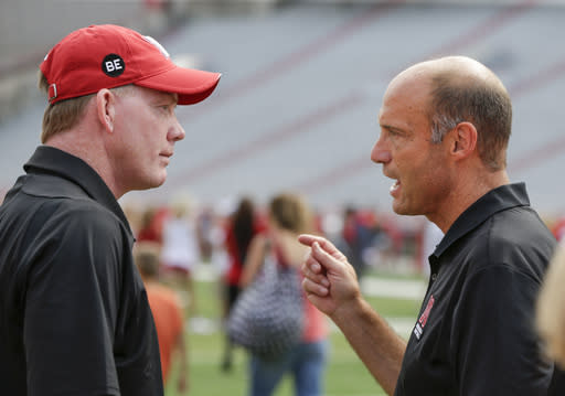 Nebraska football head coach Mike Riley (R) chats with Shawn Eichorst during fan day in Lincoln. Nebraska fired Eichorst on Thursday. (AP)