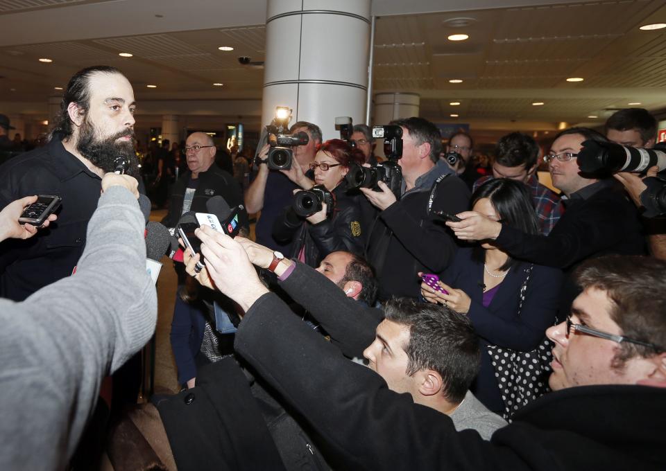 Canadian Greenpeace activist Alexandre Paul speaks to the media as he arrives at airport in Montreal