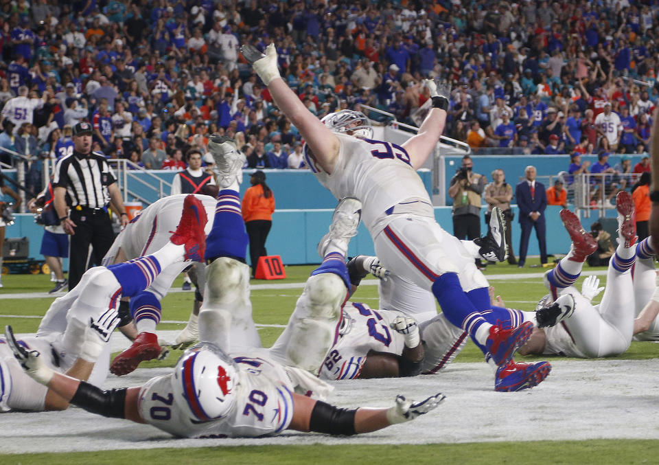 Bills defensive tackle Kyle Williams (95) and his teammates fall to the ground in celebration after Williams scored a touchdown on Sunday. (AP)