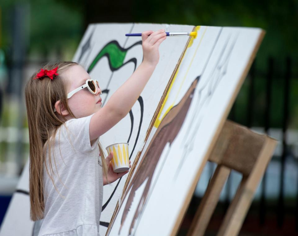 Main Street Kent's Wizardly World of Kent weekend takes over the Downtown. Everly Garner, 4, of Kent, paints a section in the "paint by number" community art project.