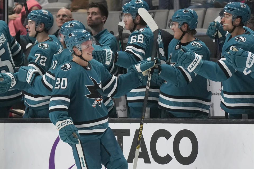 San Jose Sharks left wing Fabian Zetterlund (20) is congratulated for his goal against the Vancouver Canucks during the second period of an NHL hockey game in San Jose, Calif., Saturday, Nov. 25, 2023. (AP Photo/Jeff Chiu)