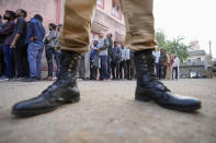 People stand in queue to cast their votes during the first phase of Gujarat state legislature elections in Limbadi, India, Thursday, Dec. 1, 2022. The voting in Prime Minister Narendra Modi’s home state’s local elections is seen as a barometer of his ruling Bharatiya Janata Party’s popularity ahead of a general election in 2024. (AP Photo/Ajit Solanki)