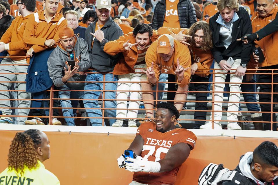 Christian Jones takes a selfie with fans after the Longhorns' win over Texas Tech on Nov. 24. It was his final game at Royal-Memorial Stadium.