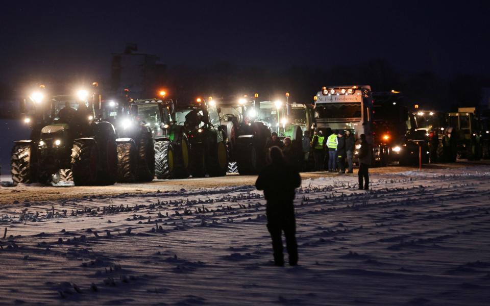 German farmers take part in a protest against the cut of vehicle tax subsidies