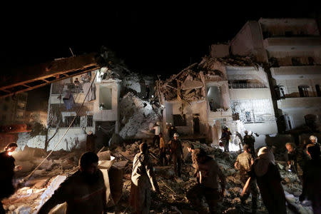 Civilians and civil defence members look for survivors at a site damaged after Russian air strikes on the Syrian rebel-held city of Idlib, Syria. REUTERS/Khalil Ashawi