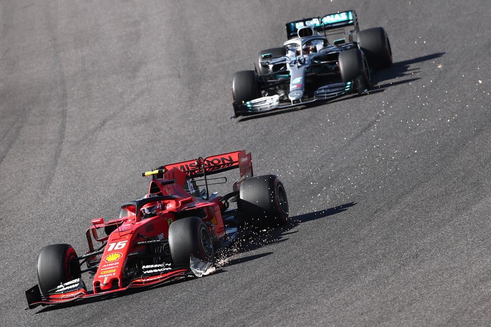 Sparks fly as Ferrari's Monegasque driver Charles Leclerc (L) leads Mercedes' British driver Lewis Hamilton into a turn during the Formula One Japanese Grand Prix final at Suzuka on October 13, 2019. (Photo by Behrouz MEHRI / AFP) (Photo by BEHROUZ MEHRI/AFP via Getty Images)