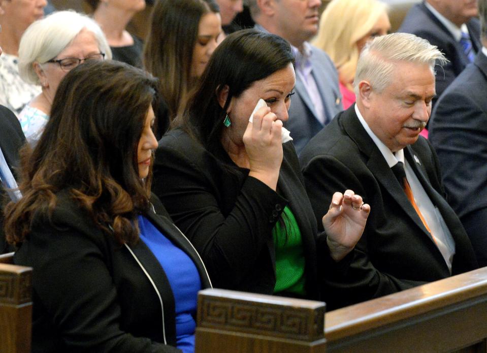 Treasurer-Elect Colleen Redpath Feger, center, wipes away tears during an ecumenical prayer service at the Cathedral of the Immaculate Conception on Friday, May 5, 2023. Redpath Feger is succeeding Misty Buscher, to Redpath Feger's right, as Buscher becomes Mayor.