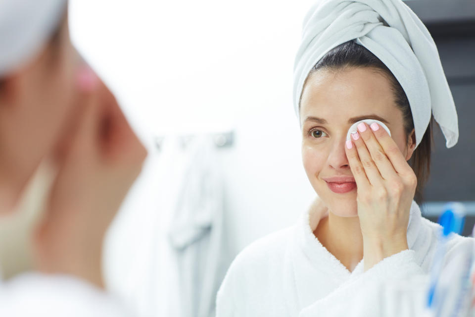 Woman removing makeup with cotton pad