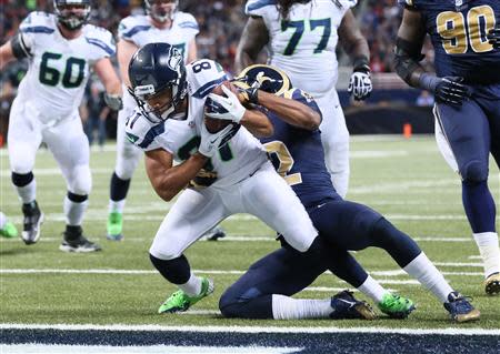 Oct 28, 2013; St. Louis, MO, USA; Seattle Seahawks wide receiver Golden Tate (81) catches a pass for a touchdown defended by St. Louis Rams cornerbacks Trumaine Johnson (23) and Janoris Jenkins (21) during the first half at Edward Jones Dome. Mandatory Credit: Nelson Chenault-USA TODAY Sports