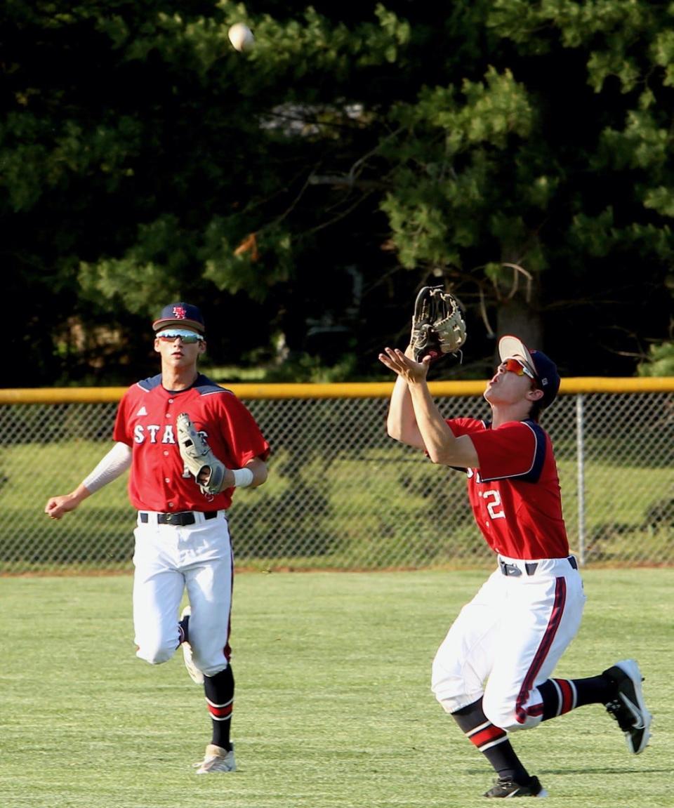 BNL right-fielder Cal Gates settles under a pop fly as center fielder Grant Dalton backs up the play last season at Seymour.