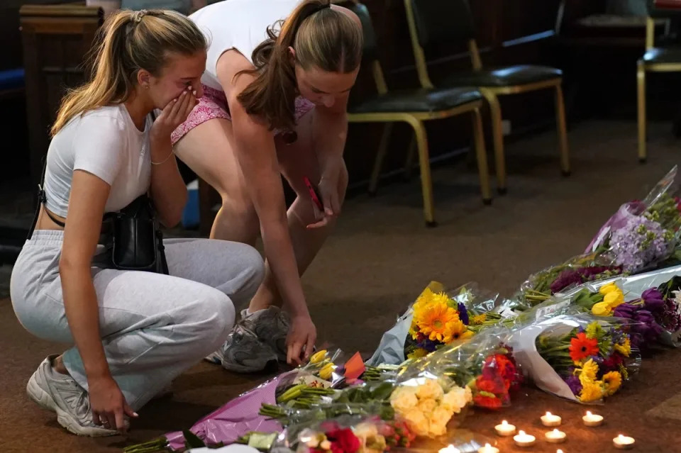 People laid flowers and candles at a vigil at St Peter's church in Nottingham on Tuesday (PA)