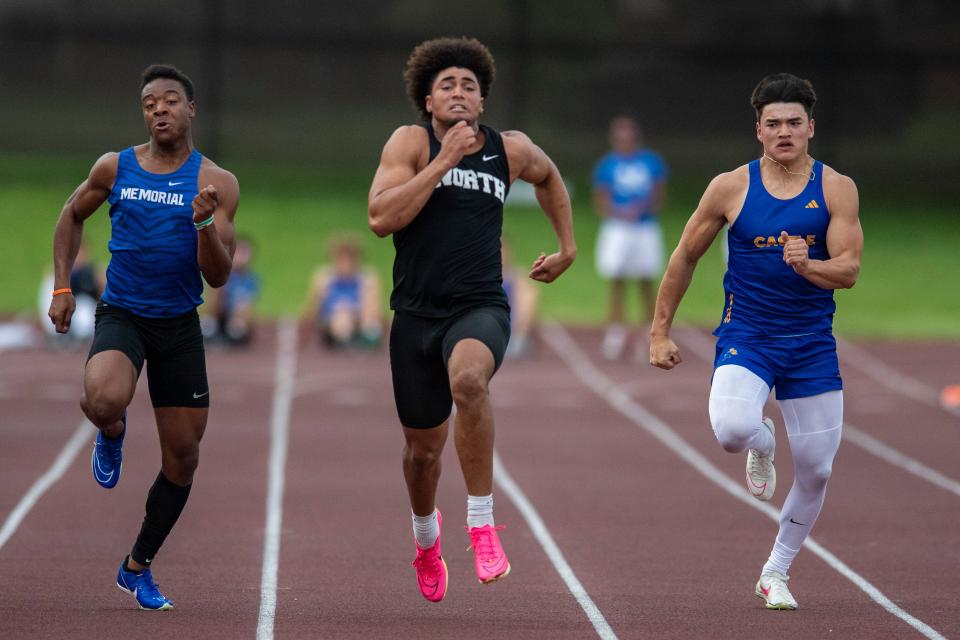 Memorial’s Dasmon Johnson, North’s Kaleb Harris and Castle’s Antonio Harris compete in the 100 meter dash during the 2024 Southern Indiana Athletic Conference Boys Track & Field meet at Central High School in Evansville, Ind., Thursday, May 2, 2024.