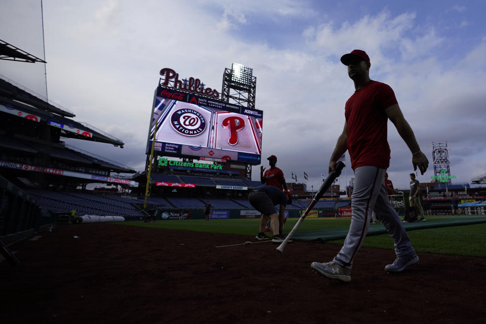 A Washington Nationals' player walks off the field as weather postpones their baseball game against the Philadelphia Phillies, Monday, Aug. 7, 2023, in Philadelphia. (AP Photo/Matt Slocum)