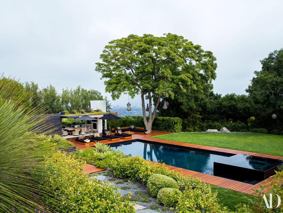 The house offers sweeping views of the city below. Marcello Villano and Anne Attinger designed the landscape. Custom teak chaise longues (on teak decking) by designer Stephen Shadley with cushions of a Perennials fabric.