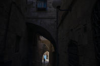 An Ultra-Orthodox Jewish man walks towards the Western Wall, the holiest site where Jews can pray in Jerusalem's old city ahead of Yom Kippur, the holiest day in the Jewish year which starts at sundown Sunday during a three-week nationwide lockdown to curb the spread of the coronavirus, Sept. 27, 2020. (AP Photo/Ariel Schalit)