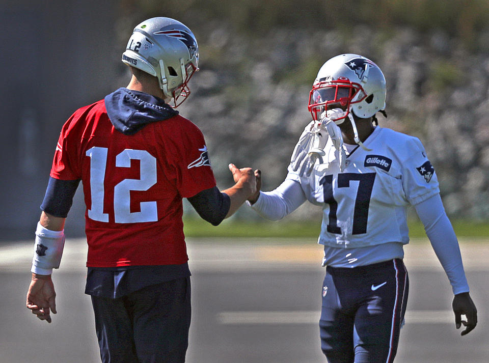 New England Patriots quarterback Tom Brady greets Antonio Brown (17) at a practice during Brown's short stay with the Patriots. (Getty Images)