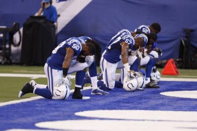 A group of Colts players kneel during the anthem. (Reuters)