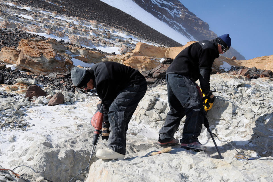 Field Museum paleontologists Peter Makovicky and Nathan Smith remove rock at the Mount Kirkpatrick quarry containing Cryolophosaurus fossils, during a 2010-2011 expedition in Antarctica. <cite>Copyright The Field Museum</cite>