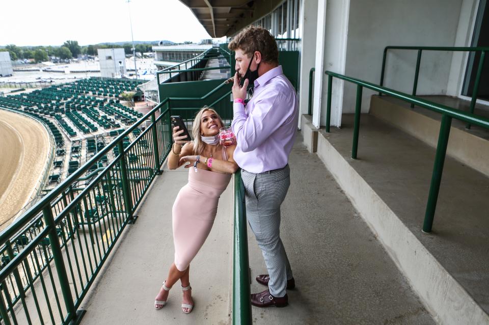 Jared Katz and girlfriend Julia Bortolazzo, whose father owns 2020 Kentucky Derby contender Money Moves, relax on Millionaires rows in a mostly empty Churchill Downs grandstand on Oaks Day. Churchill Downs only allowed horse owners, their families, trainers and a select amount of media due to the Covid-19 pandemic. Sept. 4, 2020