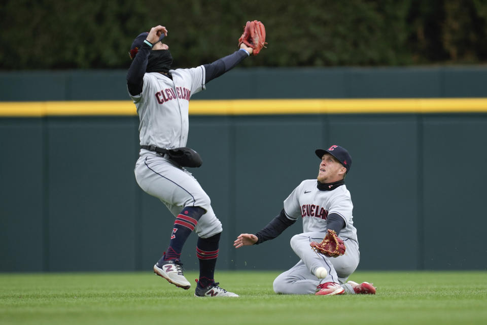 Cleveland Guardians second baseman Andres Gimenez, left, and center fielder Myles Straw can't reach a Detroit Tigers' Javier Baez fly ball in the fourth inning of the second game of a doubleheader baseball game in Detroit, Tuesday, April 18, 2023. (AP Photo/Paul Sancya)