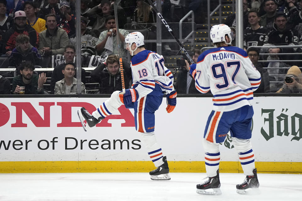 Edmonton Oilers left wing Zach Hyman, left, celebrates his goal as center Connor McDavid follows during Game 3 of an NHL hockey Stanley Cup first-round playoff series against the Los Angeles Kings Friday, April 26, 2024, in Los Angeles. (AP Photo/Mark J. Terrill)