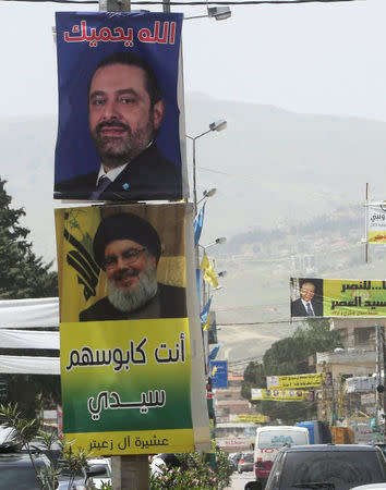 Posters of Lebanese Prime Minister and candidate for parliamentary election Saad al-Hariri and Lebanon's Hezbollah leader Sayyed Hassan Nasrallah hang along a street in Zahle, Lebanon May 4, 2018. REUTERS/Aziz Taher