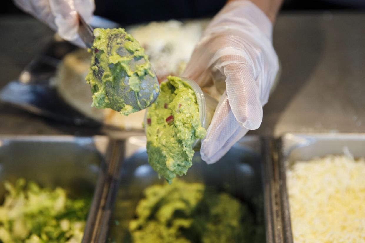 An employee scoops guacamole at a Chipotle Mexican Grill Inc. restaurant in El Segundo, California, U.S., on Wednesday, July 25, 2018. Chipotle is scheduled to release earnings figures on July 26.