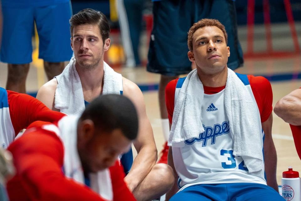 Charlie McElveen and Austin Scott sit on the floor of a basketball court in a still from ‘Clipped’