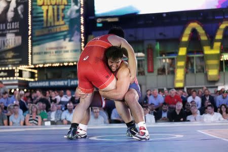 U.S. wrestler Nick Gwiazdowski (R) spars with Japanese wrestler Katsutoshi Kanazawa at the "Beat The Streets" wrestling event in Times Square, New York City, U.S., May 17, 2017. REUTERS/Joe Penney