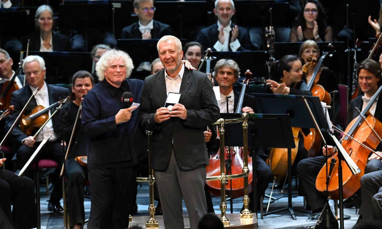 <span>Two of Britain’s most consistently original talents … Simon Rattle presents Thomas Adès with the Royal Philharmonic Society’s gold medal.</span><span>Photograph: Chris Christodoulou</span>