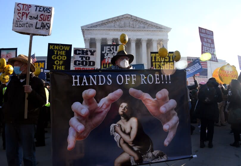 Abortion rights advocates and anti-abortion protesters demonstrate in front of the US Supreme Court in Washington, DC, on December 1, 2021. - The justices weigh whether to uphold a Mississippi law that bans abortion after 15 weeks and overrule the 1973 Roe v. Wade decision. (Photo by OLIVIER DOULIERY / AFP) (Photo by OLIVIER DOULIERY/AFP via Getty Images)