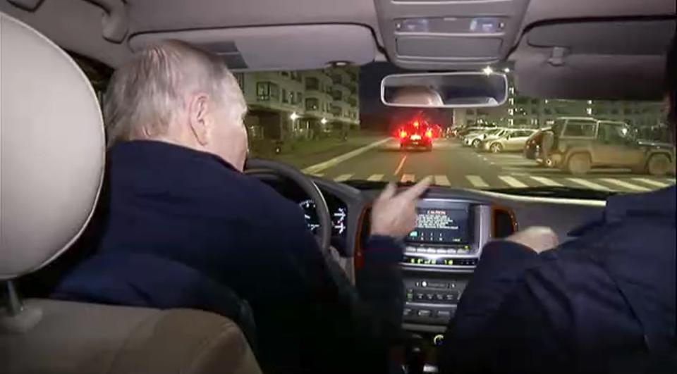 In this photo taken from video released by Russian Presidential Press Office on Sunday, March 19, 2023, Russian President Vladimir Putin, left, and Russian Deputy Prime Minister Marat Khusnullin, right, drive a car during their visit to Mariupol in Russian-controlled Donetsk region, Ukraine. Putin has traveled to Crimea to mark the ninth anniversary of the Black Sea peninsula's annexation from Ukraine. (Russian Presidential Press Office via AP)