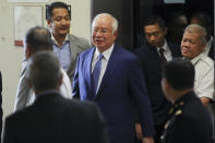 Former Malaysian Prime Minister Najib Razak, center, arrives at Kuala Lumpur High Court in Kuala Lumpur, Malaysia, Wednesday, Aug. 28, 2019. His second trial is due to begin Wednesday. (AP Photo/Vincent Thian)