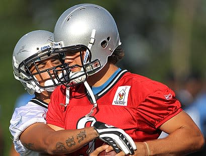 Matthew Stafford practices with rookie cornerback Aaron Berry at training camp