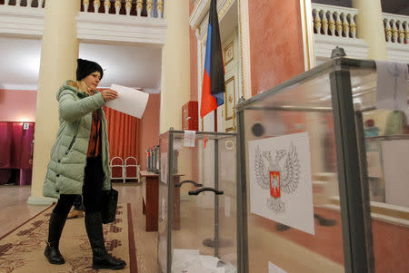 A woman votes during leadership elections in rebel-controlled Donetsk, Ukraine November 11, 2018. REUTERS/Alexander Ermochenko