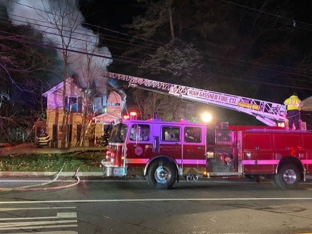 Firefighters battle flames burning a house illegally used as a boarding house at 510 Chestnut Ridge Road in Chestnut Ridge
