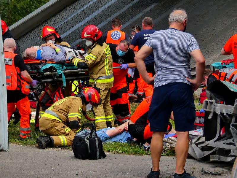 First responders attend to the scene of a public bus crash in Warsaw