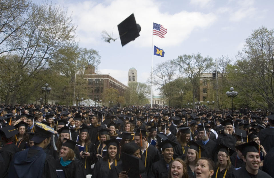 FILE - In this Saturday, April 26, 2008, file photo, University of Michigan graduates celebrate after their spring commencement ceremony, in Ann Arbor, Mich. The University of Michigan in Ann Arbor is one of 55 colleges and universities facing federal investigation for their handling of sexual abuse allegations. The school says the probe involves the school’s handling of a reported 2009 violation of its sexual misconduct policy by then-football placekicker Brendan Gibbons, who was expelled in December. (AP Photo/Tony Ding, File)