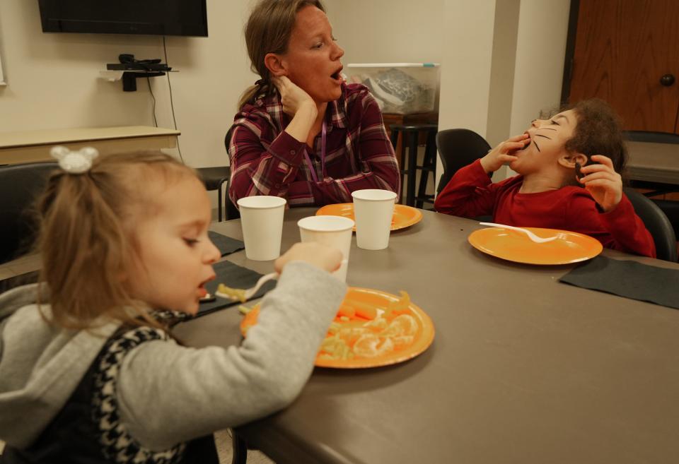Corrin Knebel jokes around with children while they eat dinner at a three-generation English as a Second Language program run by Festa, a local nonprofit group. The program is run out of the  Indian Run United Methodist Church in Dublin (pictured here) and another church in Hilliard.