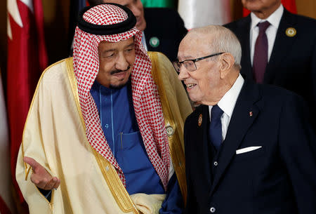 Saudi Arabia's King Salman bin Abdulaziz speaks with Tunisian President Beji Caid Essebsi during the group photo with Arab leaders, ahead of the 30th Arab Summit in Tunis, Tunisia March 31, 2019. REUTERS/Zoubeir Souissi/Pool
