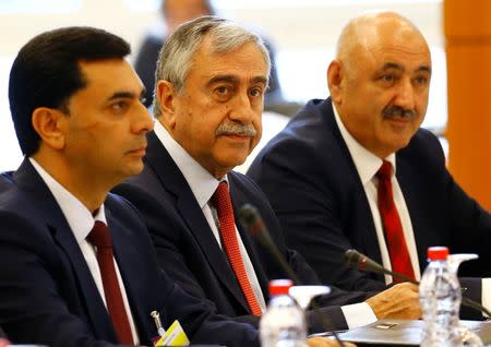 Turkish Cypriot leader Mustafa Akinci (C) attends the start of the peace talks on divided Cyprus under the supervision of the United Nations in the alpine resort of Crans-Montana, Switzerland June 28, 2017. REUTERS/Denis Balibouse?