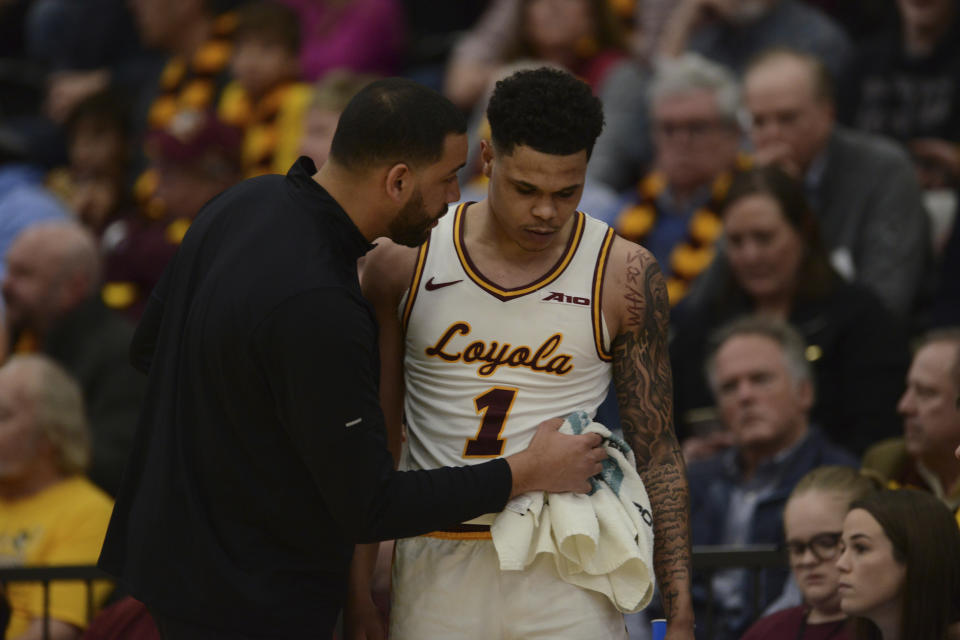 Loyola of Chicago head coach Drew Valentine, left, talks with Jayden Dawson (1) during the first half of an NCAA college basketball game against Dayton, Friday, March 1, 2024, in Chicago. (AP Photo/Paul Beaty)