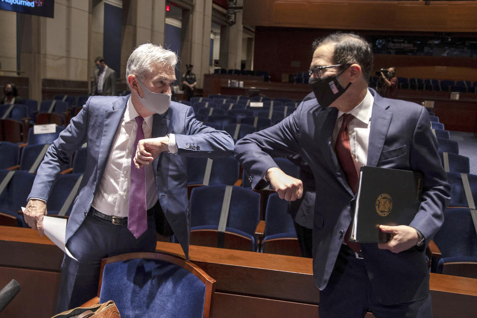 Federal Reserve Board Chairman Jerome Powell, left, and Treasury Secretary Stephen Mnuchin, bump elbows at the conclusion of a House Committee on Financial Services hearing on oversight of the Treasury Department and Federal Reserve pandemic response, Tuesday, June 30, 2020 on Capitol Hill in Washington. (Tasos Katopodis/Pool via AP)